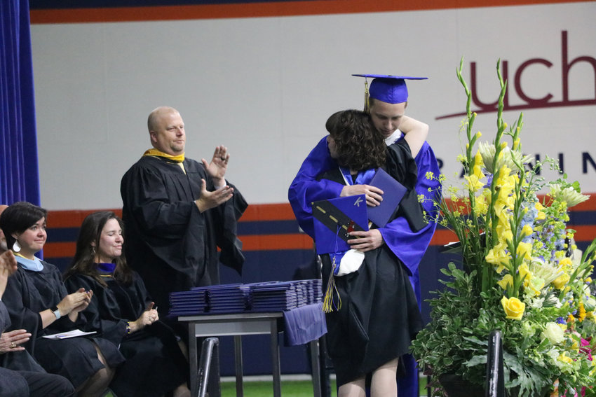 STEM School Highlands Ranch graduate Jordon Monk accepts Kendrick Castillo's diploma at a May 20 commencement ceremony at the Broncos Training Facility. Castillo, who would have graduated with his classmates, was killed in a school shooting two weeks before.